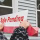 Picture of hands holding a “sale pending” sign